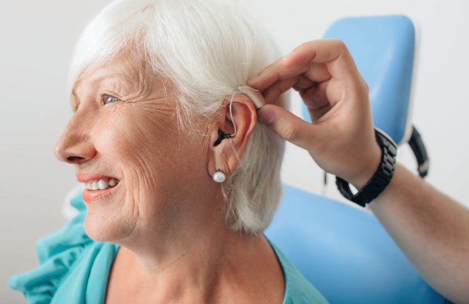 A patient getting fitted with hearing aids