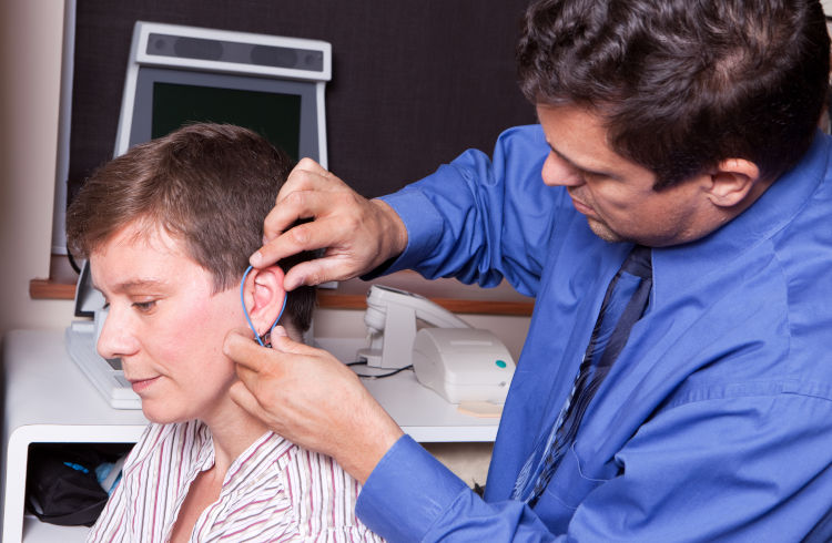 A patient getting her hearing aids verified with real ear measurement